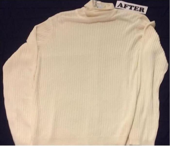 White sweater cleaned of all soot