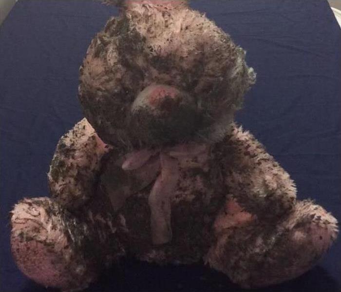Pink stuffed bunny covered in soot