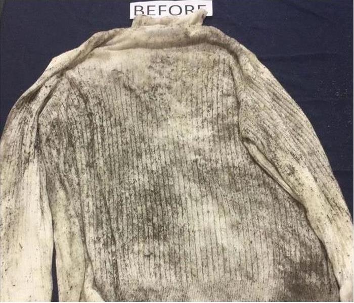 White sweater covered in soot