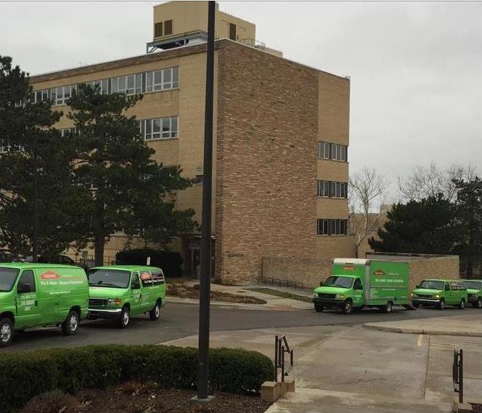 SERVPRO trucks outside a commercial building