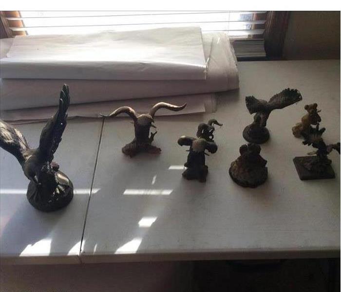Figurines affected by fire and smoke damage